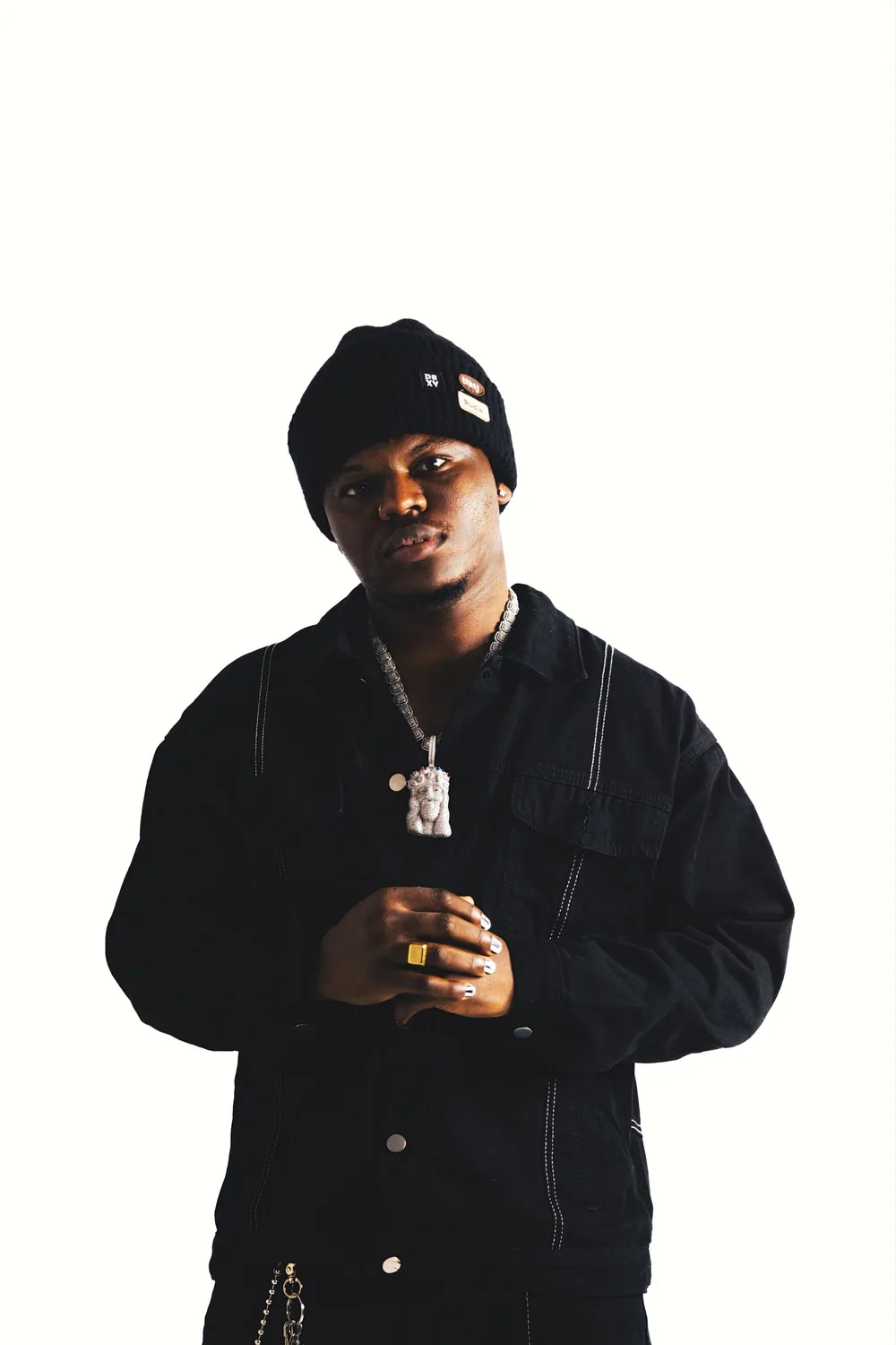 Gbejuloban wearing black against a white background